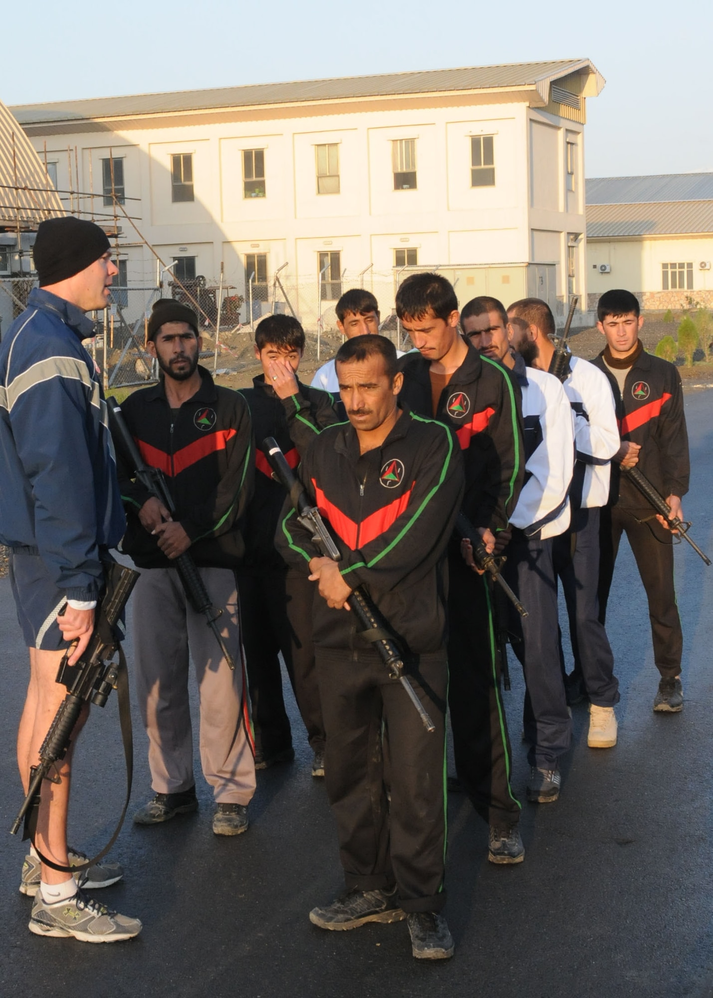 Members of the Afghan Air Force Security Force engage in physical fitness with NATO Air Training Command - Afghanistan advisor, Capt. Robert Shaw on Sept 30, 2010.  (U.S. Navy photo by MC3 Jared Walker/RELEASED).