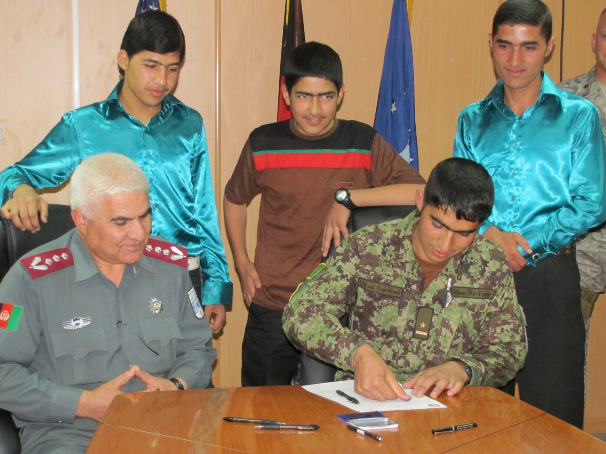 Afghan Air Force Thunder Lab Lieutenants Sign their service commitments prior to leaving for pilot training in the Unites States on the air force base in Kabul on October 3, 2010. (Mass Communications Specialist First Class Elizabeth Burke/RELEASED).