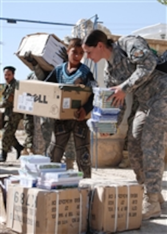 U.S. Army soldiers assigned to the 10th Mountain Division and Regional Support Command-North and Afghan National Army soldiers assigned to the 209th Corps hand out school supplies to Nawabad School in Deh Dadi district, Afghanistan, on Sept. 30 2010.  The school provides secondary education to nearly 1,000 students in the area despite shattered windows and deteriorated wooden ceilings.  The classes are so large the school rotates through three shifts each day to accommodate the students.  
