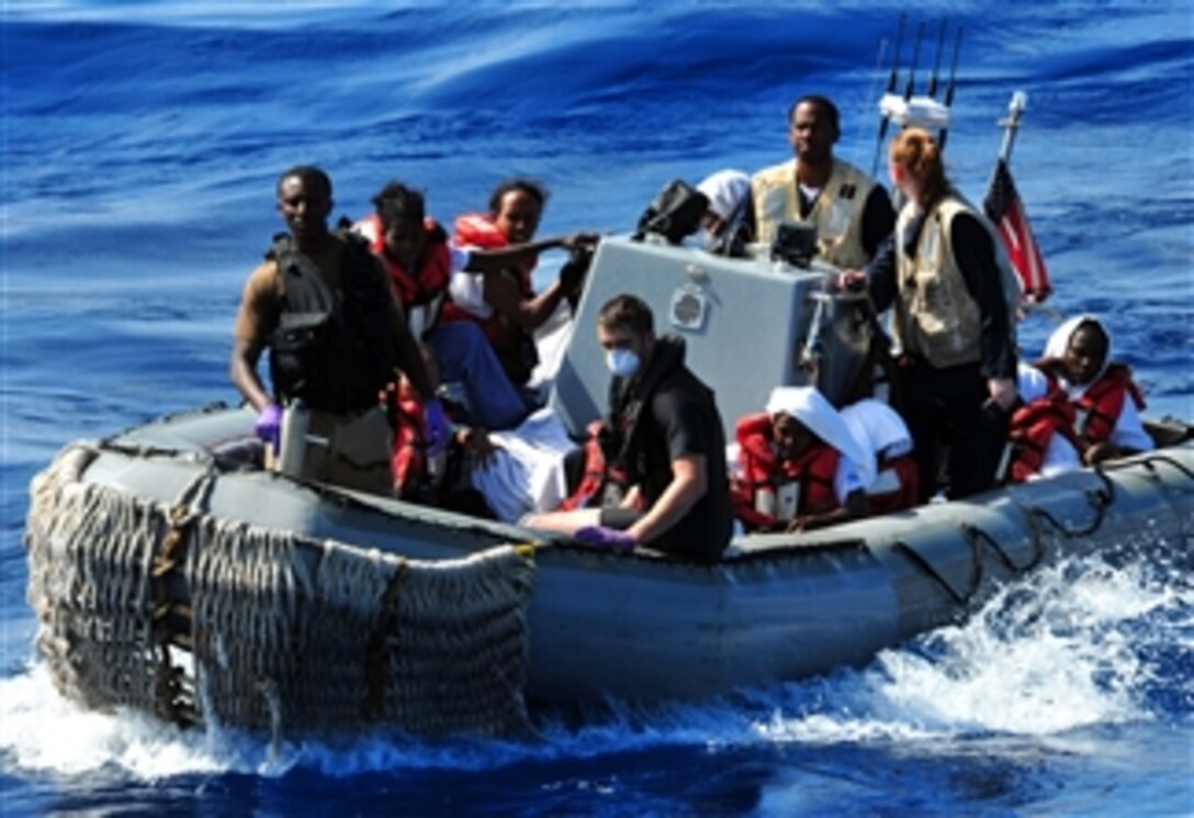 U.S. service members transport rescued persons through the Gulf of Aden in a rigid-hull inflatable boat to the amphibious dock ship USS Pearl Harbor (LSD 52) on Sept. 29, 2010.  The personnel were rescued on Sept. 27, 2010, by sailors assigned to the USS Winston S. Churchill (DDG 81) after their small boat capsized.  The rescued persons were first brought aboard the Winston S. Churchill where they received food, water and medical attention before being transferred to the Pearl Harbor.  