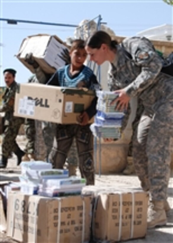 U.S. Army soldiers assigned to the 10th Mountain Division and Regional Support Command-North and Afghan National Army soldiers assigned to the 209th Corps hand out school supplies to Nawabad School in Deh Dadi district, Afghanistan, on Sept. 30 2010.  The school provides secondary education to nearly 1,000 students in the area despite shattered windows and deteriorated wooden ceilings.  The classes are so large the school rotates through three shifts each day to accommodate the students.  