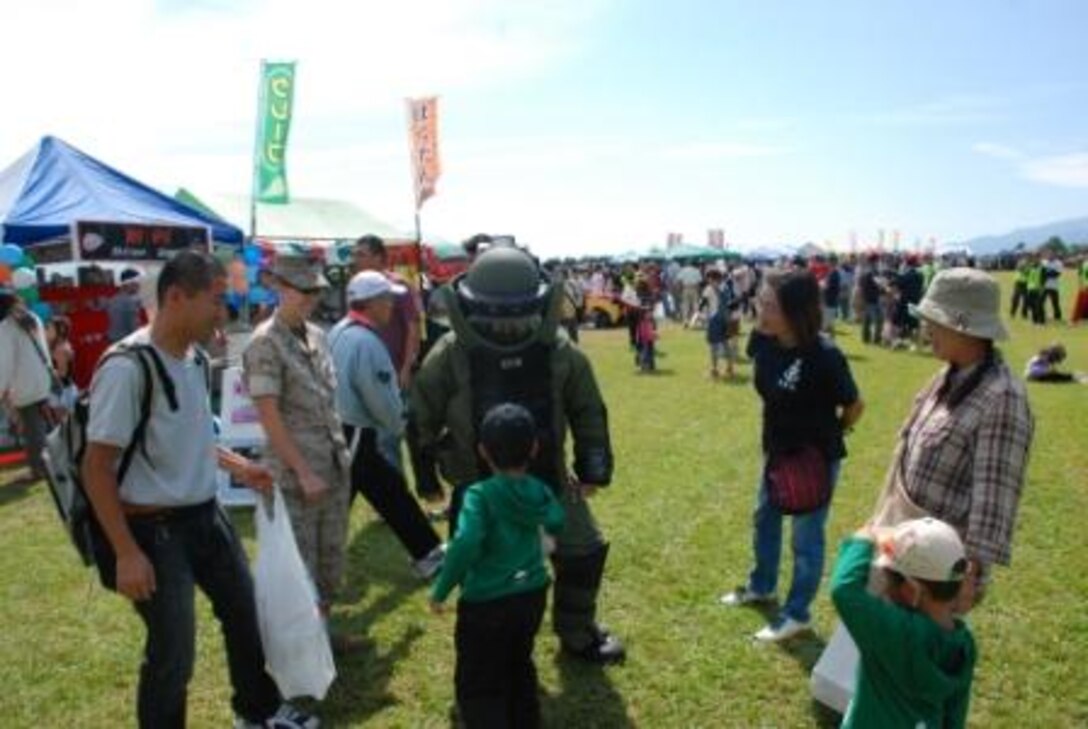 An EOD Marine in a protective suit and Sgt Riley display the versatility of the suit.