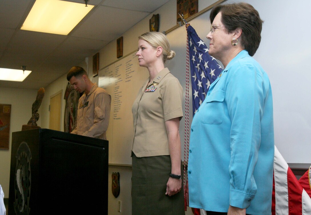 Capt. Alexis Paschedag, a UH-1Y "Huey" helicopter pilot, and retired Maj. Gen. Teresa Peterson, the first woman in the Air Force to command an aviation squadron, stand at attention during an award ceremony at Marine Corps Base Camp Pendleton Oct. 4. During the event, Paschedag was awarded the Order of Daedalians 2009 Exceptional Pilot Award.