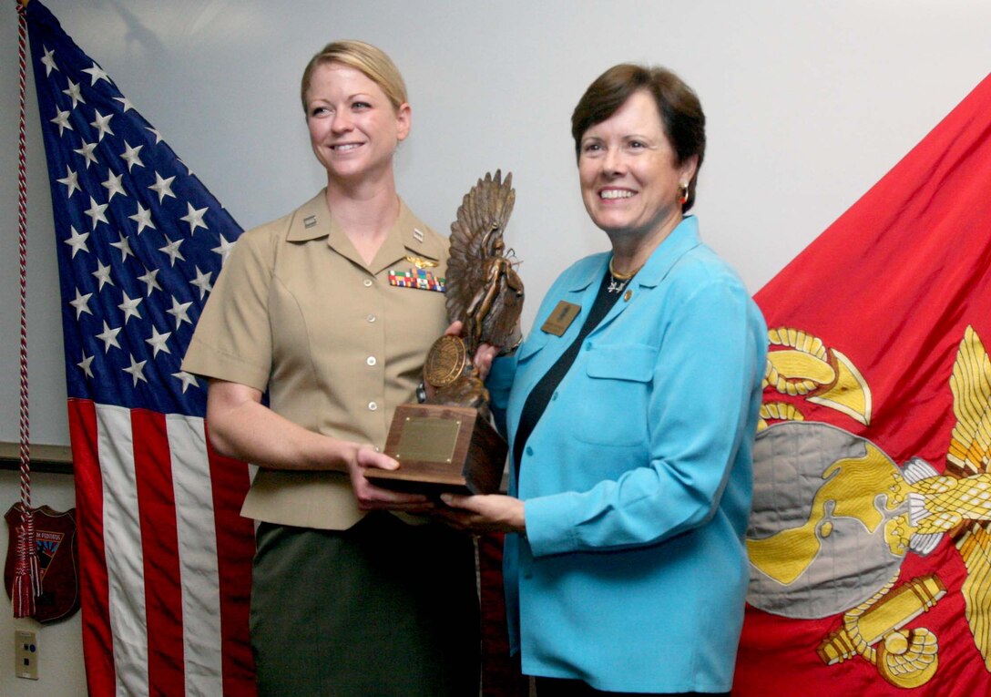 Capt. Alexis Paschedag, a UH-1Y "Huey" helicopter pilot, receives the Order of Daedalians 2009 Exceptional Pilot Award from retired Maj. Gen. Teresa Peterson, the first woman in the Air Force to command an aviation squadron, at Marine Corps Base Camp Pendleton Oct. 4. Paschedag was selected for the award because of actions while deployed with Marine Light Attack Helicopter Squadron 367 in Afghanistan.