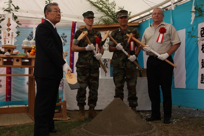 From left to right, Eiji Hirata, vice president of Nishimatsu Construction Company, Cmdr. Jason Zeda, resident officer-in charge of construction, Lt. Pil Park, assistant resident officer in-charge of construction, and Kirby Franklin, base housing directer, pose for a photo during the groundbreaking ceremony for the renovations to Buildings 1191 and 1200 here Oct. 5.