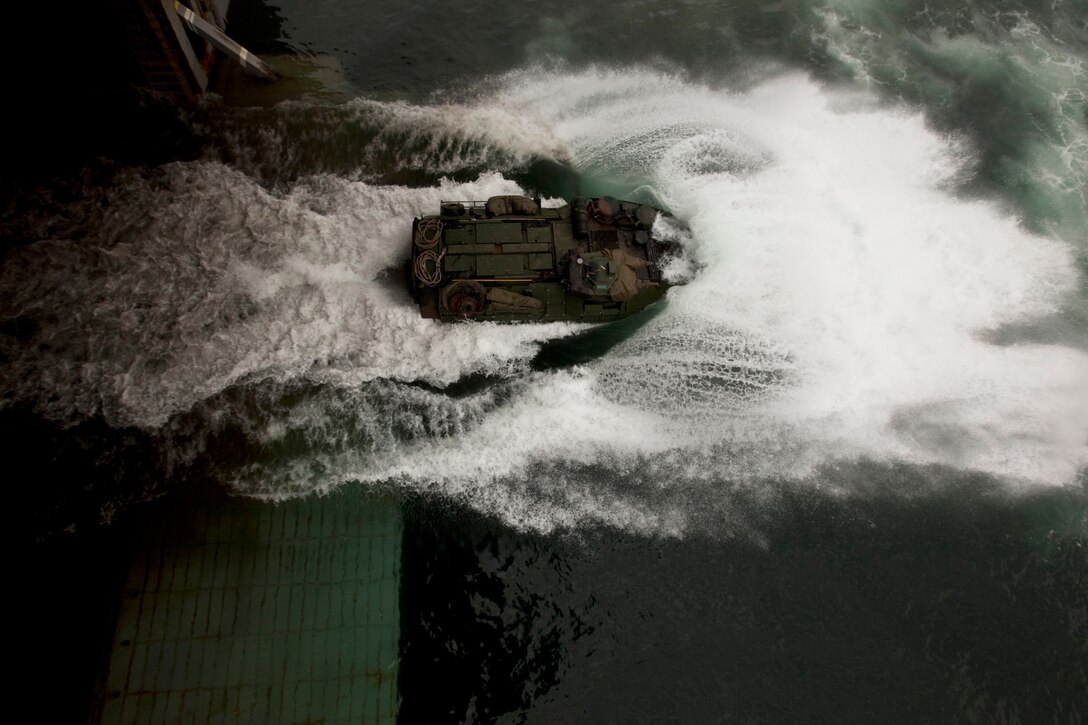 An amphibious assault vehicle, with Company A, 2nd Assault Amphibian Battalion, attached to Special-Purpose Marine Air-Ground Task Force Continuing Promise 2010, departs the well deck of the amphibious assault ship USS Iwo Jima (LHD7), during demonstrations for service members and civilians, off the coast of Chiriqui Grande, Panama, Oct. 5. Service members and civilians are deployed in support of CP10 providing medical, dental, veterinary, engineering assistance and subject-matter exchanges to Caribbean, Central and South American nations.