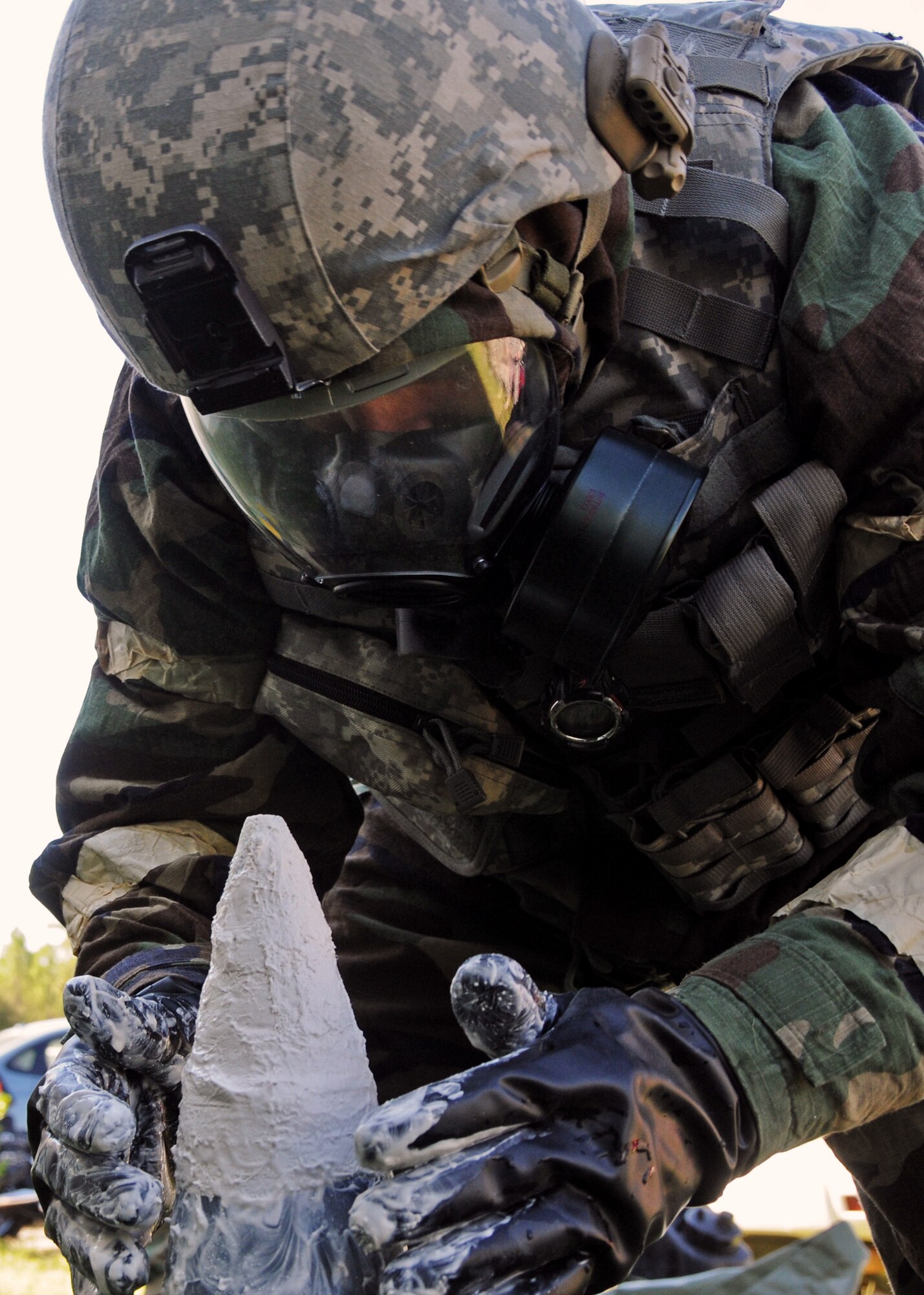 Tech. Sgt. Greg Locke, 919th Civil Engineer Squadron explosive ordnance disposal, attaches an adhesive to the contaminated ordnance after it was discovered at the 919th Maintenance Group building during Day two of the wing’s Ability to Survive and Operate exercise, Oct. 3 at Duke Field, Fla.  The Reserve unit exercised preparing deployers, Mission Oriented Protective Posture and command and control procedures during the Unit Training Assembly weekend.  (U.S. Air Force photo/Tech. Sgt. Samuel King Jr.)