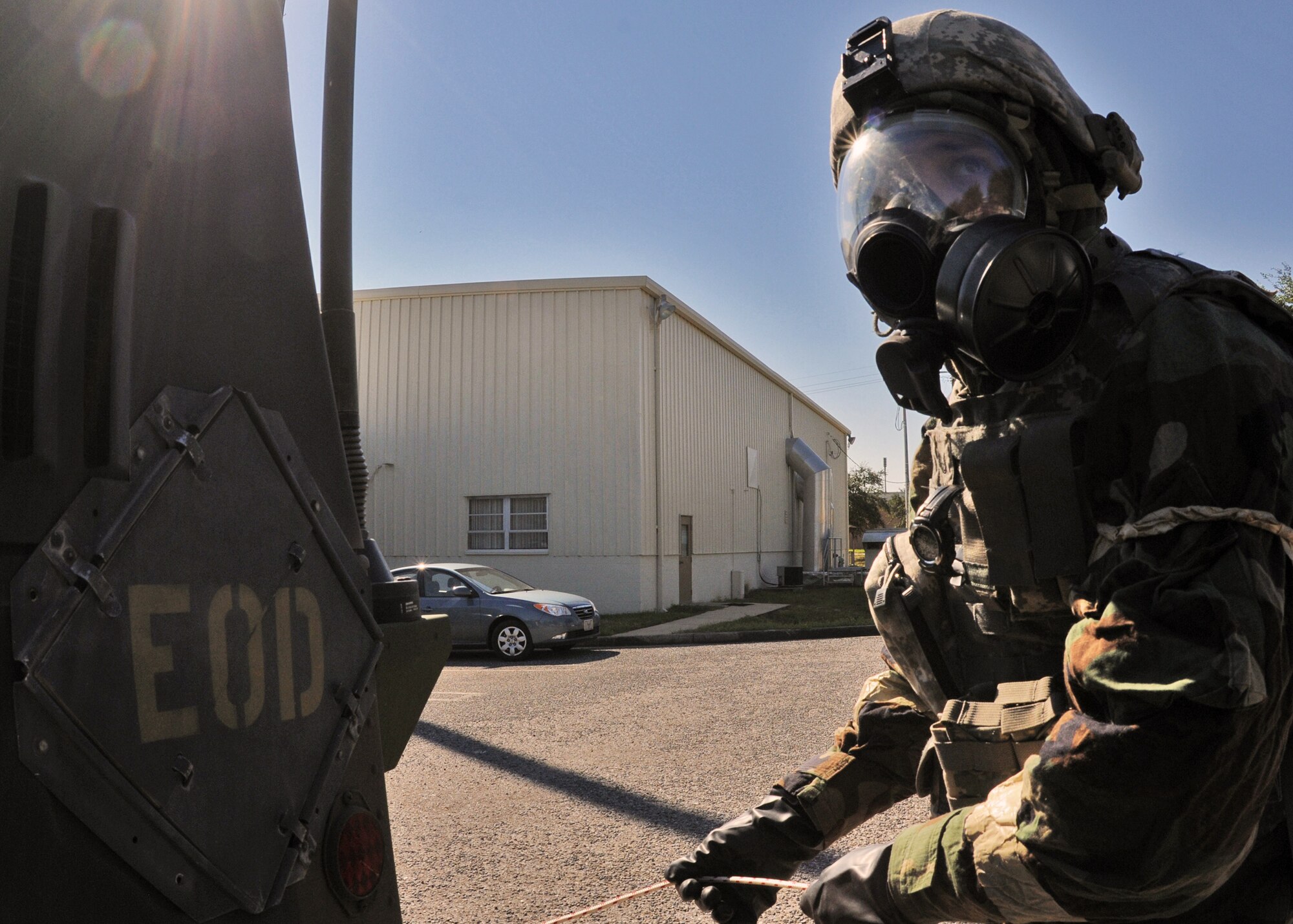 Tech. Sgt. Scott McCulley, 919th Civil Engineer Squadron explosive ordnance disposal, verifies the area is clear before moving the simulated contaminated ordnance after it was discovered at the 919th Maintenance Group building during Day two of the wing’s Ability to Survive and Operate exercise, Oct. 3 at Duke Field, Fla.  The Reserve unit exercised preparing deployers, Mission Oriented Protective Posture and command and control procedures during the Unit Training Assembly weekend.  (U.S. Air Force photo/Tech. Sgt. Samuel King Jr.)