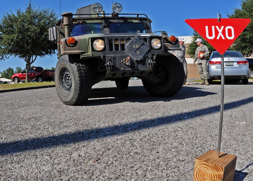 The explosive ordnance disposal Humvee moves into place after a contaminated ordnance was discovered at the 919th Maintenance Group building during Day two of the wing’s Ability to Survive and Operate exercise, Oct. 3 at Duke Field, Fla.  The Reserve unit exercised preparing deployers, Mission Oriented Protective Posture and command and control procedures during the Unit Training Assembly weekend.  (U.S. Air Force photo/Tech. Sgt. Samuel King Jr.)