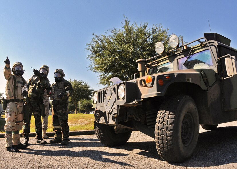 Explosive Ordnance Disposal members assess the situation after a contaminated ordnance was discovered at the 919th Maintenance Group building during Day two of the wing’s Ability to Survive and Operate exercise, Oct. 3 at Duke Field, Fla.  The Reserve unit exercised preparing deployers, Mission Oriented Protective Posture and command and control procedures during the Unit Training Assembly weekend.  (U.S. Air Force photo/Tech. Sgt. Samuel King Jr.)
