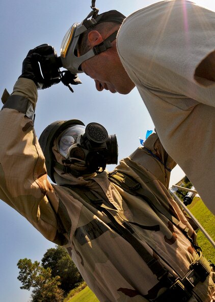 Tech. Sgt. Manuel Sanchez Jr., 919th Maintenance Squadron, removes the gas mask of a contamination victim at the last station of the decontamination area during Day two of the 919th Special Operations Wing’s Ability to Survive and Operate exercise, Oct. 3 at Duke Field, Fla.  The Reserve unit exercised preparing deployers, Mission Oriented Protective Posture and command and control procedures during the Unit Training Assembly weekend.  (U.S. Air Force photo/Tech. Sgt. Samuel King Jr.)