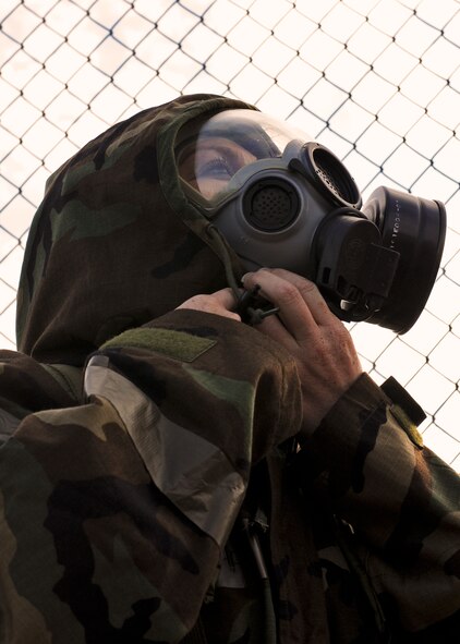 Senior Airman Melissa Spell, 919th Special Operations Wing, finishes closing off the neck of her chemical protective suit during Day two of the wing’s Ability to Survive and Operate exercise, Oct. 3 at Duke Field, Fla.  The Reserve unit exercised preparing deployers, Mission Oriented Protective Posture and command and control procedures during the Unit Training Assembly weekend.  (U.S. Air Force photo/Tech. Sgt. Samuel King Jr.)