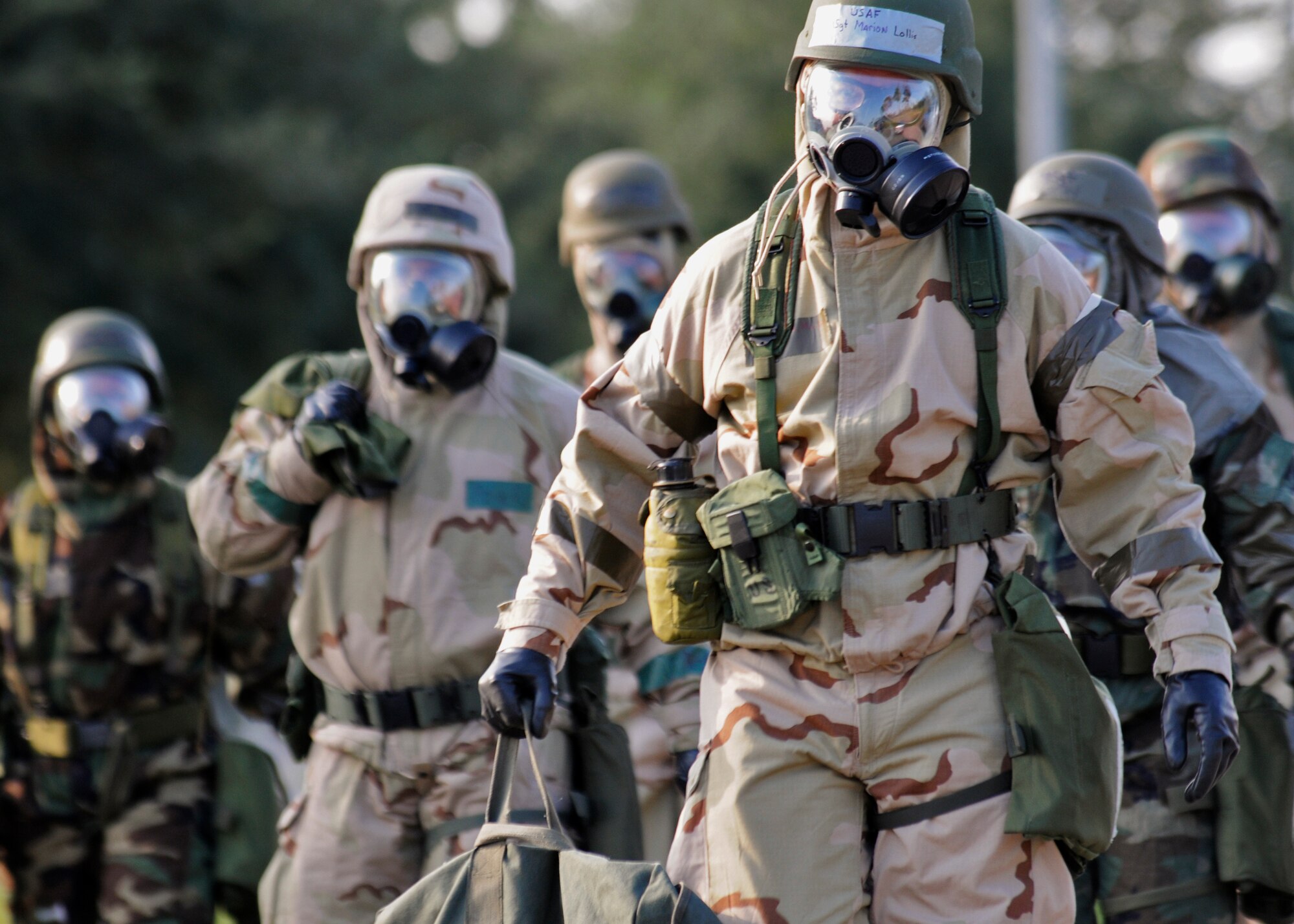 Simulated contaminated 919th Special Operations Wing Airmen walk to the decontamination area during Day two of the 919th Special Operations Wing’s Ability to Survive and Operate exercise, Oct. 3 at Duke Field, Fla.  The Reserve unit exercised preparing deployers, Mission Oriented Protective Posture and command and control procedures during the Unit Training Assembly weekend.  (U.S. Air Force photo/Tech. Sgt. Samuel King Jr.)