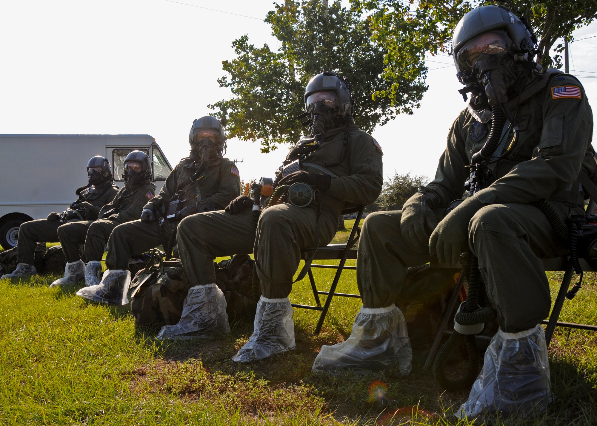 Aircrew members of the 711th Special Operations Squadron sit in their Aircrew Eye Respiratory Protective Systems during Day two of the wing’s Ability to Survive and Operate exercise, Oct. 3 at Duke Field, Fla.  The Reserve unit exercised preparing deployers, Mission Oriented Protective Posture and command and control procedures during the Unit Training Assembly weekend.  (U.S. Air Force photo/Tech. Sgt. Samuel King Jr.)