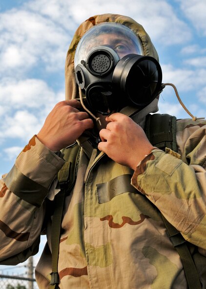 Senior Airman Ian Drain closes off the neck in his chemical warfare suit during Day two of the wing’s Ability to Survive and Operate exercise, Oct. 3 at Duke Field, Fla.  The Reserve unit exercised preparing deployers, Mission Oriented Protective Posture and command and control procedures during the Unit Training Assembly weekend.  (U.S. Air Force photo/Tech. Sgt. Samuel King Jr.)