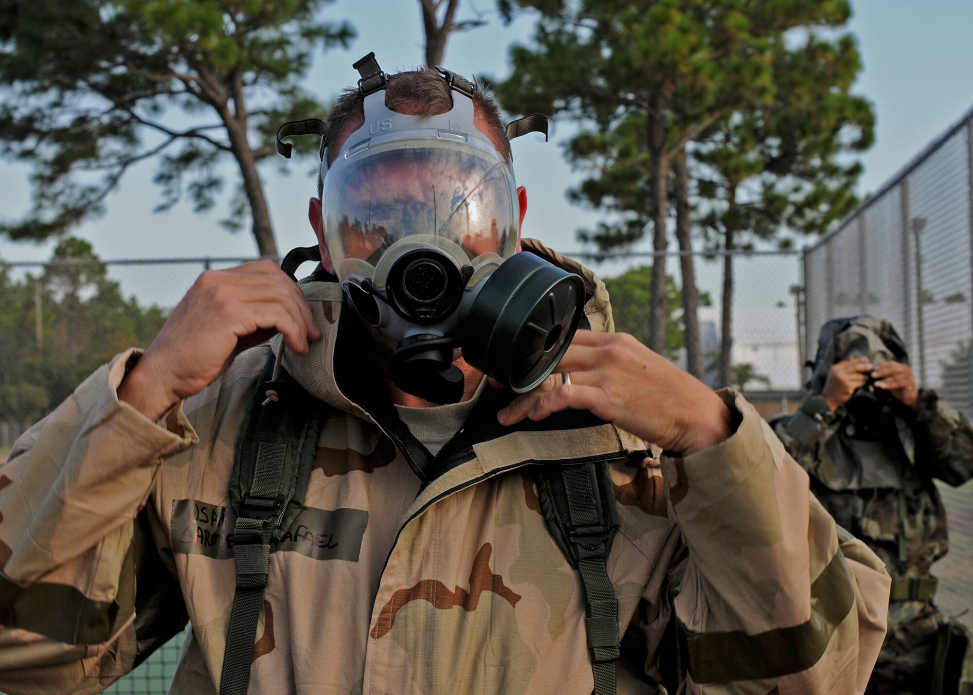 Tech. Sgt. Rafael Sarmiento, 919th Special Operations Wing, adjusts his gas mask during Day two of the wing’s Ability to Survive and Operate exercise, Oct. 3 at Duke Field, Fla.  The Reserve unit exercised preparing deployers, Mission Oriented Protective Posture and command and control procedures during the Unit Training Assembly weekend.  (U.S. Air Force photo/Tech. Sgt. Samuel King Jr.)