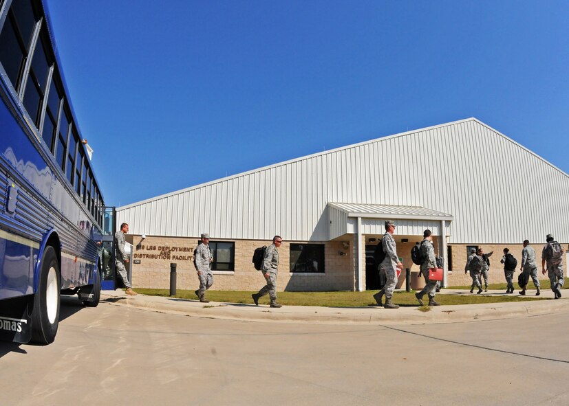 Simulated deployers exit the bus and enter the readiness center for processing during Day one of the 919th Special Operations Wing’s Ability to Survive and Operate exercise, Oct. 2 at Duke Field, Fla.  The Reserve unit exercised preparing deployers, Mission Oriented Protective Posture and command and control procedures during the Unit Training Assembly weekend.  (U.S. Air Force photo/Tech. Sgt. Samuel King Jr.)