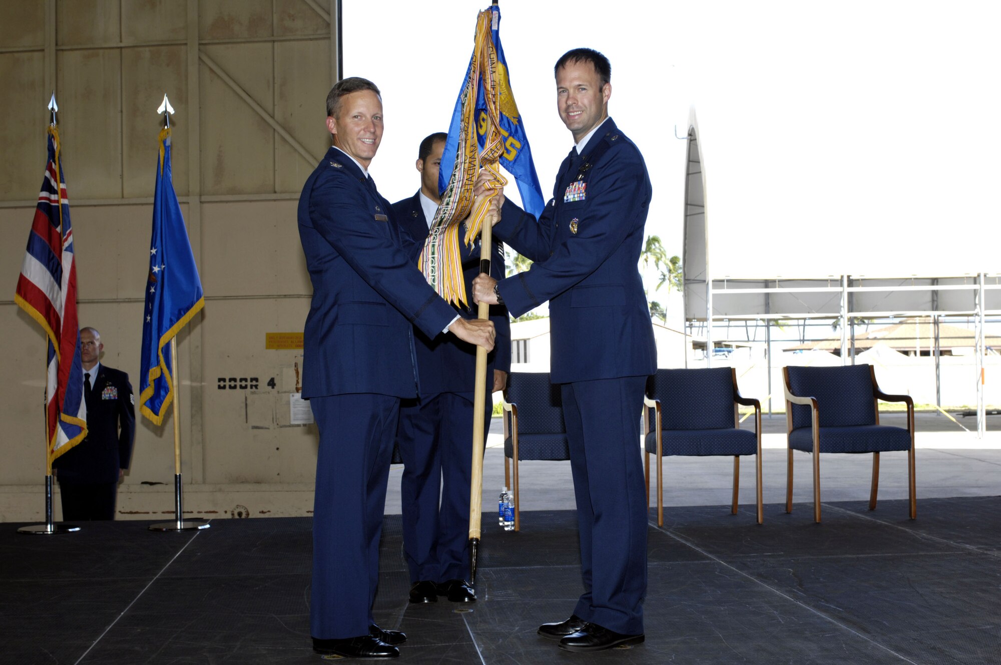 Lieutenant Colonel Harvey F. Newton, assumes command of the 19th Fighter Squadron from Colonel Jeffrey W. Morgan, 15th Operations Group commander during the 19th Fighter Squadron Realignment and Assumption of Command ceremony Oct. 4 at Joint Base Pearl harbor Hickam, Hawaii. The 19th FS will once again call Hawaii home as it spent 1923-1944 in the Hawaiian territories, including assignments at Wheeler Army Airfield, Bellows Army Airfield and Barbers Point. (Photo by David D. Underwood, Jr.)