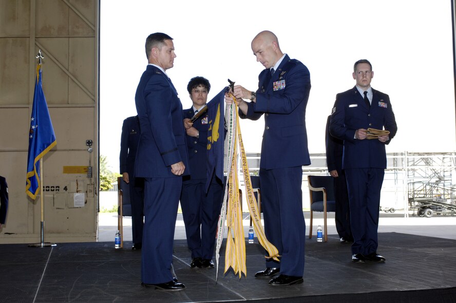 Colonel William G. Routt, 3rd Operations Group commander from Joint Base Elmendorf-Richardson, Alaska and Lieutenant Colonel Gregory J. Miller, former commander of the 19th Fighter Squadron prepare to encase the guidon flag during the 19th Fighter Squadron Realignment and Assumption of Command ceremony Oct. 4 at Joint Base Pearl harbor Hickam, Hawaii. The 19th FS will once again call Hawaii home as it spent 1923-1944 in the Hawaiian territories, including assignments at Wheeler Army Airfield, Bellows Army Airfield and Barbers Point. (Photo by David D. Underwood, Jr.)