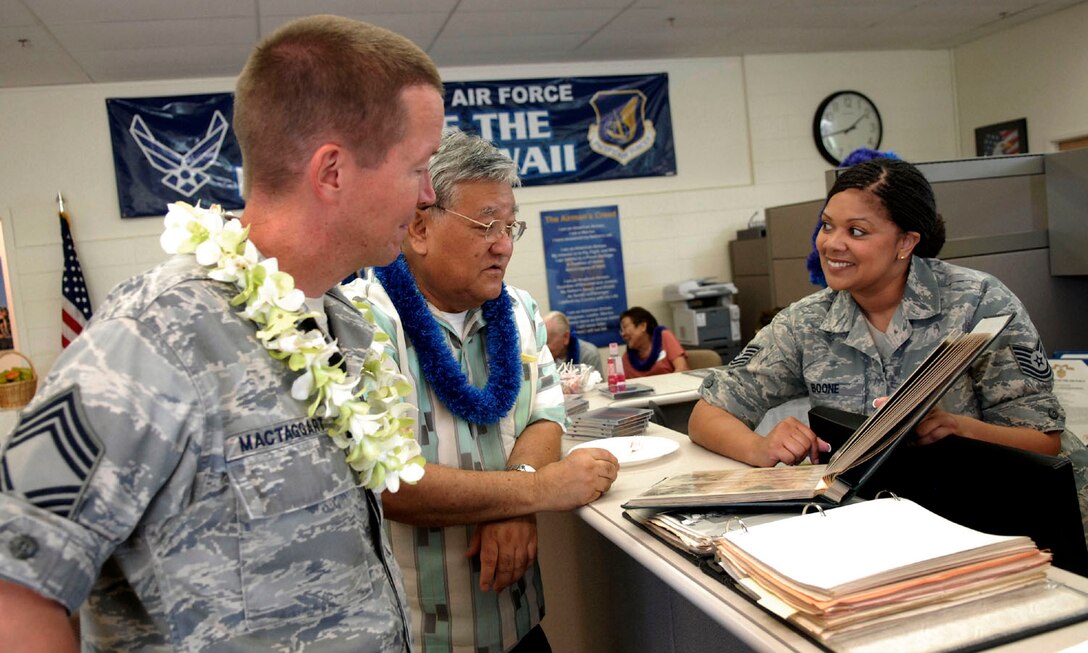 Mr. Charles Ikehara, alumni of the 501st Air Force Band, shares photos and stories about his years with the band with TSgt Tamiko Boone and CMSgt Larry MacTaggart, current members of the PACAF Band-Hawaii.