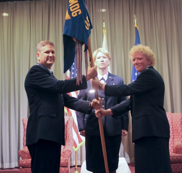 YOKOTA AIR BASE, Japan -- Colonel Lee Harvis, 374th Mediacl Group commander presents the guidon to Lt. Col. Mary O'Loughlin, the new 374th Medical Operations Squadron commander during an assumption of command here Oct. 5. (U.S. Air Force Photo/Airman 1st Class Katrina R. Menchaca)