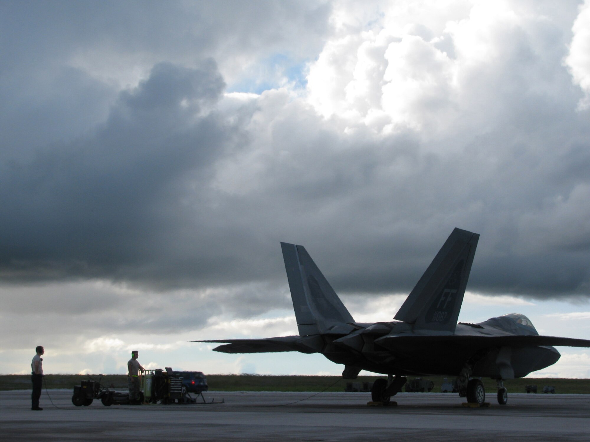 Staff Sgt. Micheal Oberst, 27th Expeditionary Fighter Squadron crew chief, and Airman 1st Class Christian Avila, 27th Expeditionary Aircraft Maintenance Unit specialist, launch an F-22 Raptor during Valiant Shield 2010 here. Both Airman are deployed to Andersen Air Force Base from Langley AFB, Va. (Courtesy photo)