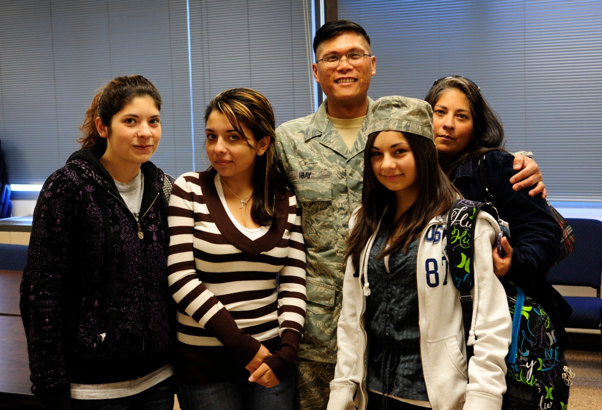 The family poses for a photo after Tech. Sgt. Raymond Ibay, 627th Air Base Group vehicle maintenance craftsman, came home unexpectedly from training and surprised his daughter, Paxton, Oct. 5 at Iva Alice Mann Middle School, Lakewood, Wash. From left to right: Rebeka, Jasmyne, Raymond, Paxton, Marjorie. (U.S. Air Force Photo/Airman Leah Young)