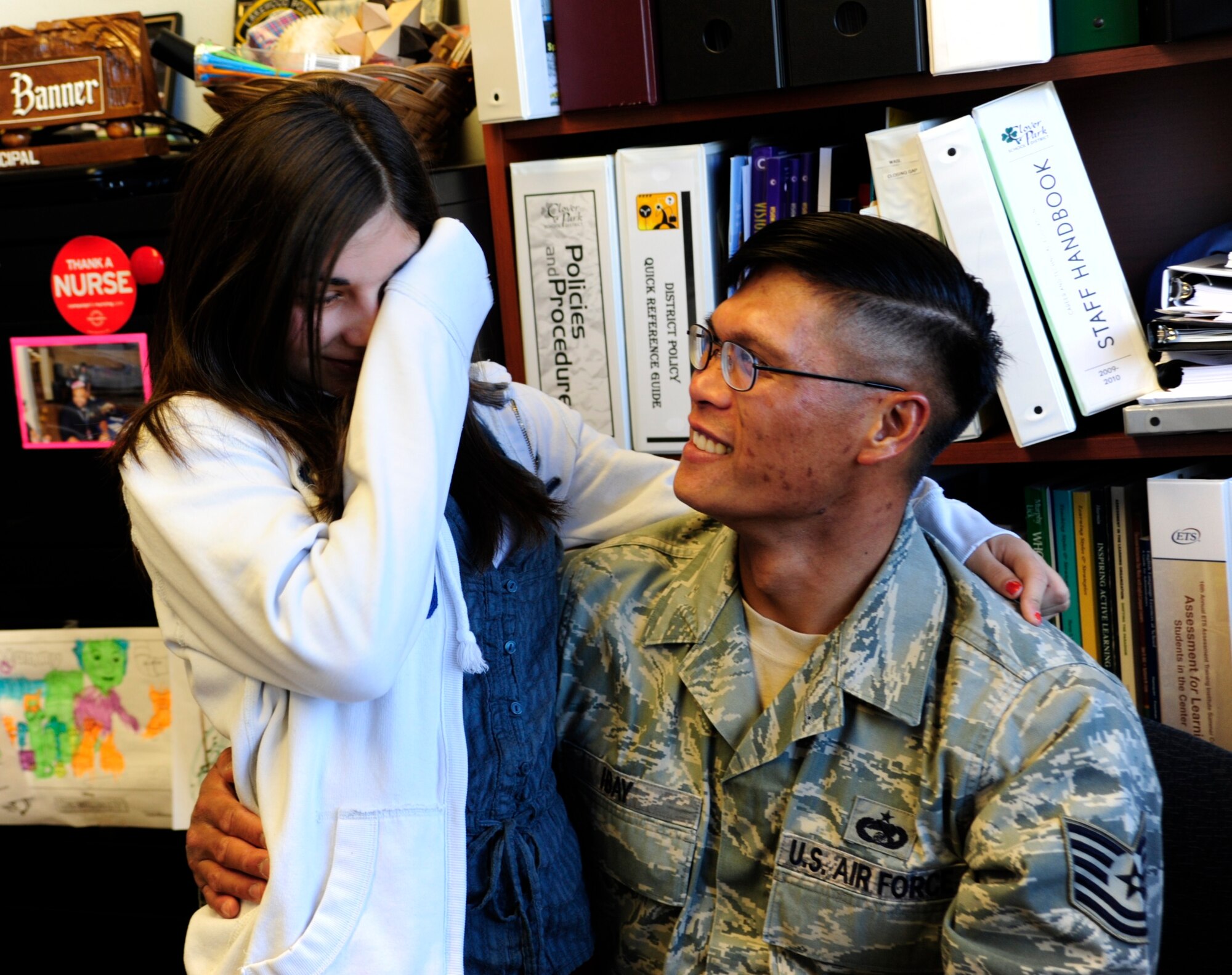 Paxton Baker wipes her eyes after her father, Tech. Sgt. Raymond Ibay, 627th Air Base Group vehicle maintenance craftsman, surprised her with his presence Oct. 5 at Iva Alice Mann Middle School, Lakewood, Wash. Sergeant Ibay was unexpectedly able to come home from training for a few days before his deployment. (U.S. Air Force Photo/Airman Leah Young)