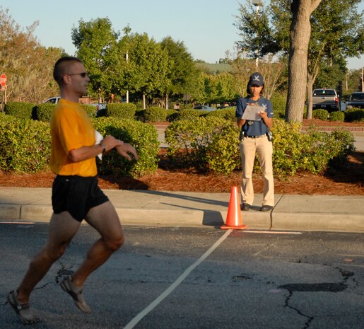 Machinist Mate 1st Class Andrew Burness crosses the finish line of the Commander?s Cup relay race Oct. 1, 2010, on Joint Base Charleston-Air Base, S.C. Machinist Mate Burness finished the seven and a half mile race in less than 45 minutes. (U.S. Air Force photo/Eric Sesit)