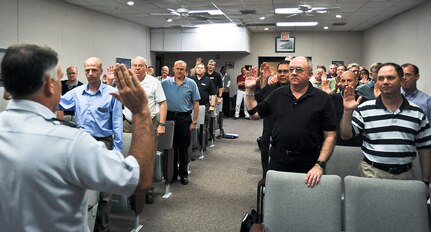 Col. Murphy, 12 Flying Training Wing Commander is giving the Oath of Allegiance to newly appointed Government Service Employees  during in-processing after converting from a contractor position.  The ceremony was held in the 12 Operational Support Squadrons DeBellevue room on October 1, 2010.  (U.S. Air Force Photo By Don Lindsey)