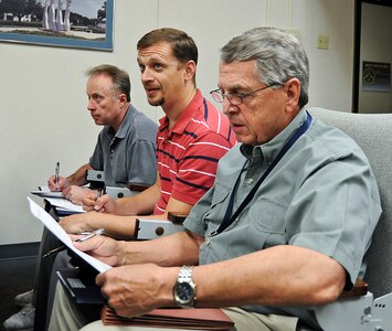 Three former contractors converted to Civil Service completing financial paper work during contractor to GS in-processing.  In processing was accomplished in the 12 OSS DeBellevue room on October 1, 2010.  (U.S. Air Force Photo By Don Lindsey)