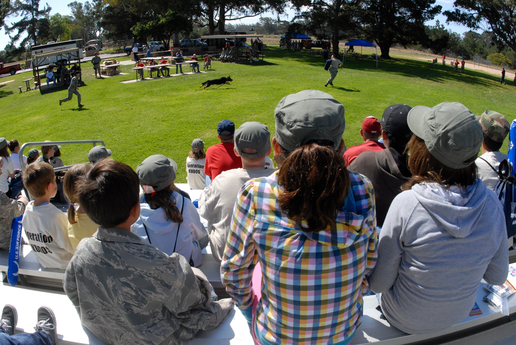 VANDENBERG AIR FORCE BASE, Calif. -- Military members and their dependents watch a 30th Security Forces Squadron K-9 training exercise during the Operation Kids Understanding Deployment Operations event at Cocheo Park here Saturday, Oct. 2, 2010.  The event showed dependents how military members prepare for deployments.  (U.S. Air Force photo/Senior Airman Andrew Satran) 
