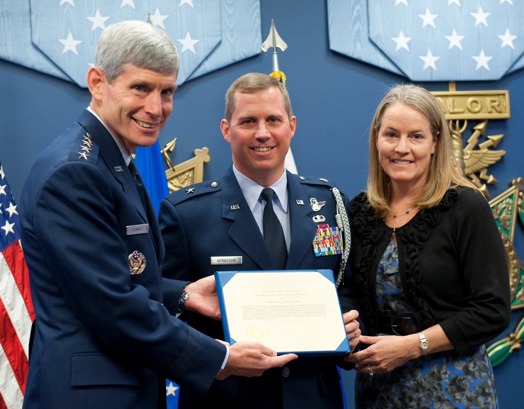 Air Force Chief of Staff Gen. Norton Schwartz (left) presents the 2010 General and Mrs. Jerome F. O'Malley award to Brig. Gen. Thomas W. Bergeson and his wife Pamela during a ceremony in the Pentagon Oct. 4, 2010. The award is presented annually to the wing commander and spouse team who have best exhibited their own courage, power, grace and beauty in caring for Air Force families. The award was established after the O'Malleys, who were known for their leadership and contributions to Air Force families and communities, were tragically killed in a plane crash in 1985. (U.S. Air Force photo/Jim Varhegyi)