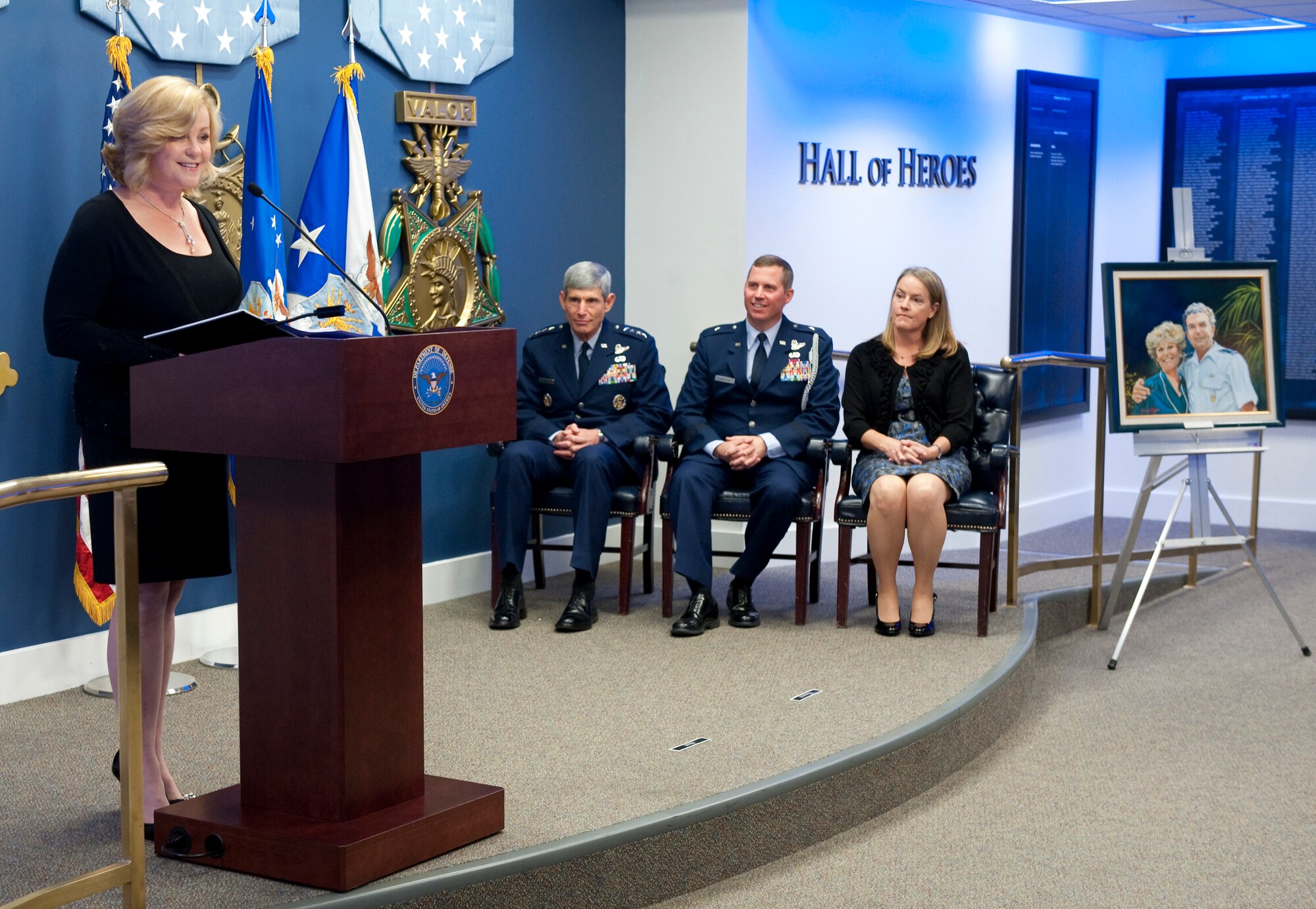 Sharon O'Malley Burg (left) talks about the legacy of her parents, General and Mrs. Jerome F. O'Malley, during a ceremony in the Pentagon Oct. 4, 2010, where Air Force Chief of Staff Gen. Norton Schwartz (seated left) presented the 2010 General and Mrs. Jerome F. O'Malley award to Brig. Gen. Thomas W. Bergeson and his wife Pamela. The award is presented annually to the wing commander and spouse team who have best exhibited their own courage, power, grace and beauty in caring for Air Force families. The award was established after the O'Malleys, who were known for their leadership and contributions to Air Force families and communities, were tragically killed in a plane crash in 1985. (U.S. Air Force photo/Jim Varhegyi)