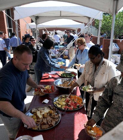 Attendees gather around buffet tables for lunch at the Joint Base Charleston inaugural open house at the Red Bank Club on JB CHS-Weapons Station, S.C., Oct. 1, 2010. The event was declared an alternate duty location for members of the 628th Air Base Wing, as members from around JB CHS gathered to celebrate the occasion. (U.S. Air Force photo/Senior Airman Timothy Taylor)
