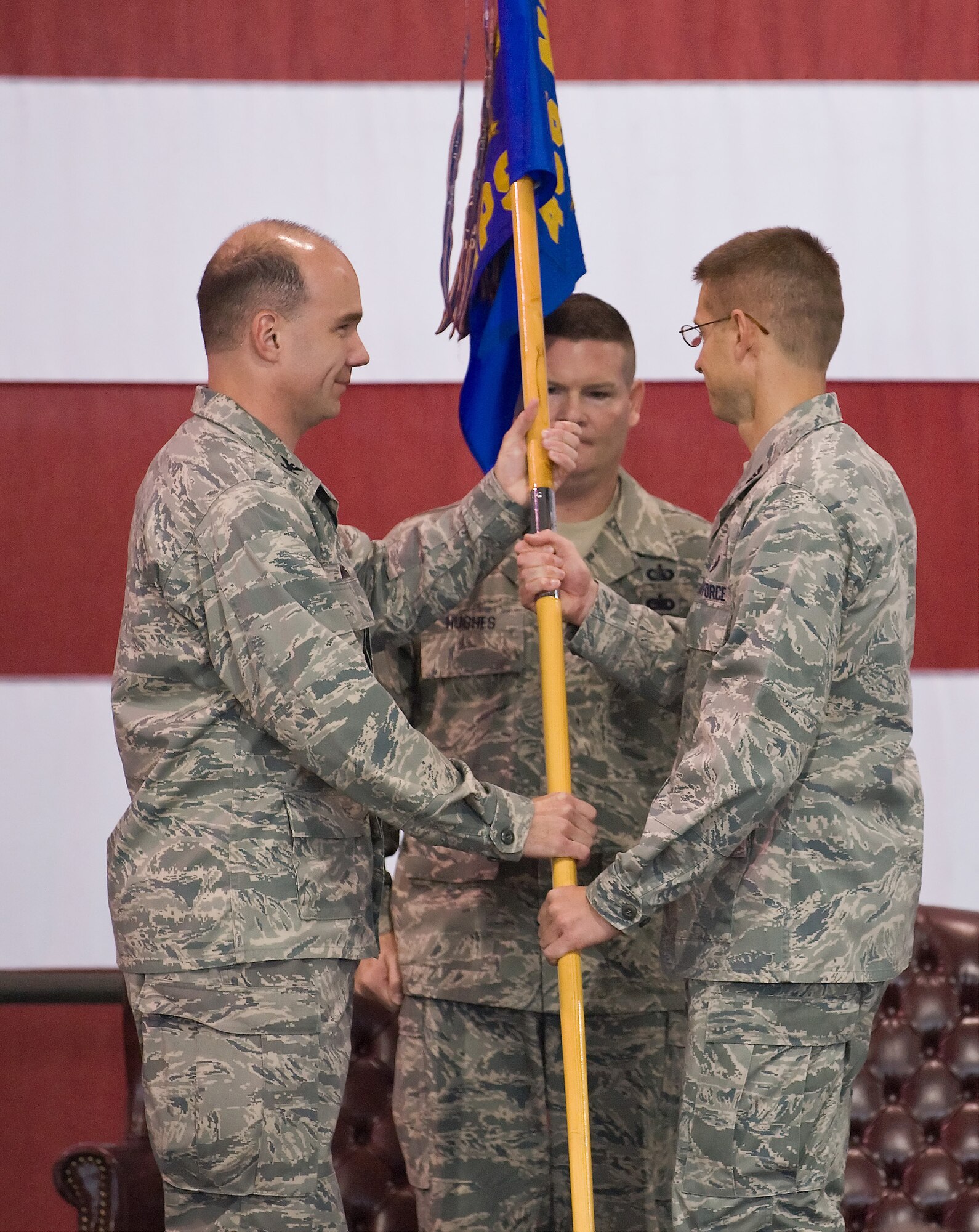 Col. Thomas Kauth, 436th Maintenance Group commander, receives the 436th Aerial Port Squadron's guidon from Col. Manson Morris, 436th Airlift Wing commander, during a re-organization ceremony at the 436th APS on Dover Air Force Base, Del., Oct. 1, 2010. This ceremony marked the movement of 436th APS to the 436th MXG from the 436th Mission Support Group. (U.S. Air Force photo by Roland Balik/Released)