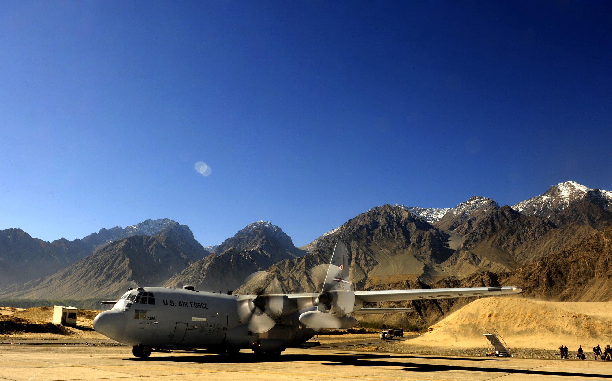 An Air Force Reserve C-130 Hercules prepares to combat offload four pallets of flood relief supplies Oct. 3 at Skardu Airport in northern Pakistan. The mission, flown by 302nd Airlift Wing aircrews from Peterson Air Force Base, Colo., who are deployed to Southwest Asia in support of U.S. Central Command operations, was one of the last fixed-wing operations supporting flood relief in Pakistan. Between Aug. 16 and Oct. 3, C-130 Hercules and C-17 Globemaster III aircraft and their aircrews transported nearly 6 million pounds of much-needed relief supplies to Pakistan aid distribution centers throughout the country. (U.S. Air Force photo/Staff Sgt. Andy Kin)