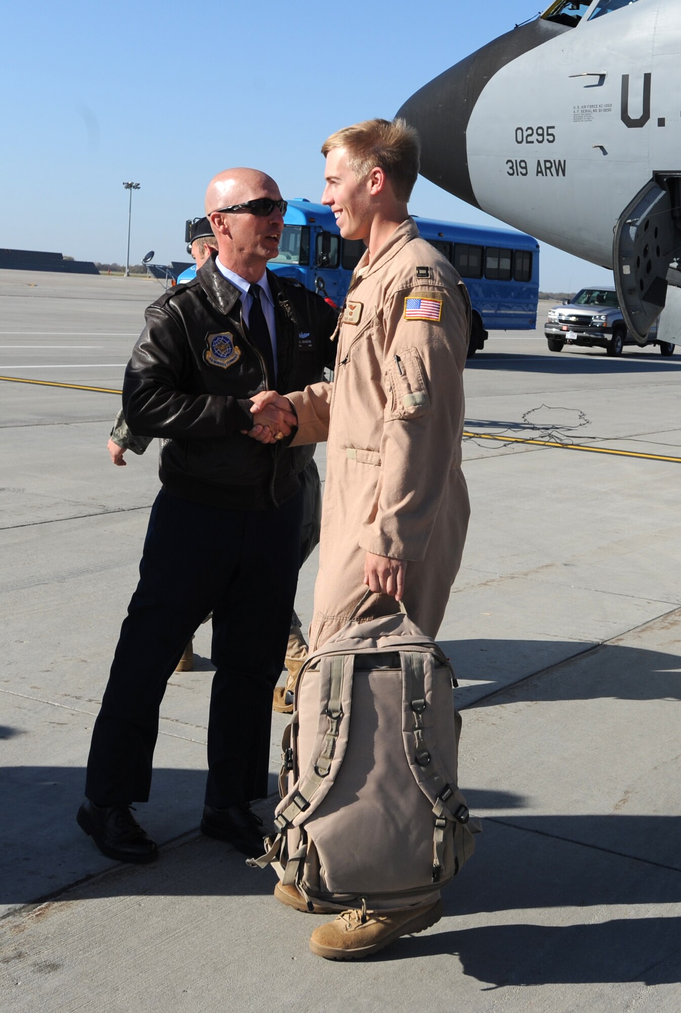 Lt. Col. Noel Bradford, 905th Air Refueling Squadron commander, welcomes Capt. Richard Adams, 905th ARS pilot, home after a deployment in support of Operation Enduring Freedom Oct. 4 at Grand Forks Air Force Base. Captain Adams was the co-pilot for the last KC-135 Stratotanker deployer from Grand Forks AFB due to the base’s transition from an aerial refueling mission to a remotely piloted aircraft mission. (U.S. Air Force photo by Staff Sgt. Suellyn Nuckolls)