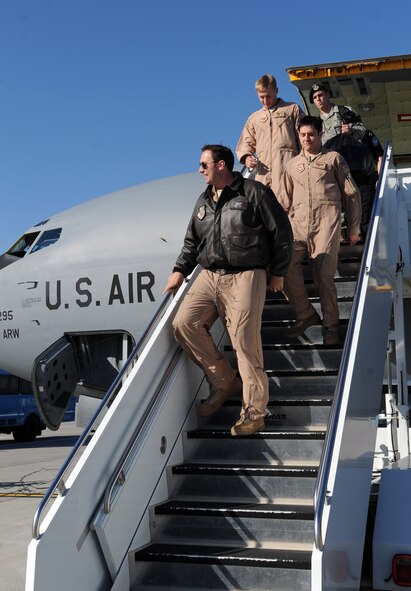 Airmen from the 905th Air Refueling Squadron look towards family and friends as they debark from a KC-135 Stratotanker after it land at Grand Forks Air Force Base, Oct. 4 from a deployment in support of Operation Enduring Freedom. This tanker was the last deployer from Grand Forks AFB due to the base’s transition from an aerial refueling mission to a remotely piloted aircraft mission. (U.S. Air Force photo by Staff Sgt. Suellyn Nuckolls)
