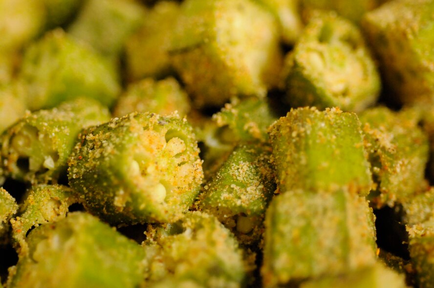 PANJSHIR PROVINCE, Afghanistan -- Tech. Sgt. Jeremy Louk, a native of Petal, Miss., deployed from Barksdale Air Force Base, La., and Provincial Reconstruction Team Panjshir engineering superintendent of construction and development, covered the okra and the other main gumbo ingredients in a mixture of 15 different spices and seasonings prior to adding them to the pot. The okra used in the gumbo was purchased in a local market in Panjshir, Afghanistan.  (U.S. Air force photo by Tech. Sgt. Sean Mateo White, PRT Panjshir photographer)(released)    