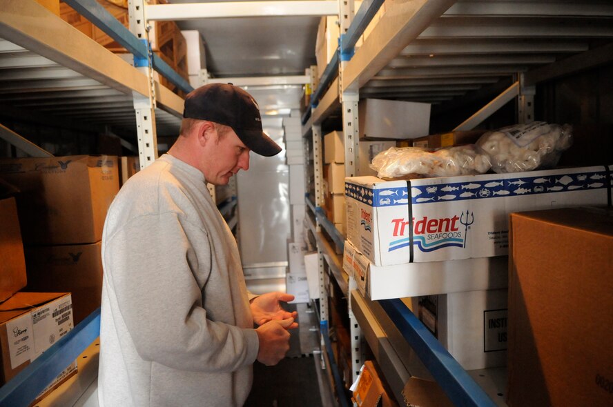 PANJSHIR PROVINCE, Afghanistan -- Tech. Sgt. Jeremy Louk, a native of Petal, Miss., deployed from Barksdale Air Force Base, La.,and Provincial Reconstruction Team Panjshir engineering superintendent of construction and development, inventories the available frozen seafood prior to making gumbo for Forward Operating Base Lion.  His gumbo consisted of more than 23 different ingredients, including shrimp, crab meat and lobster.  (U.S. Air Force photo by Tech. Sgt. Sean Mateo White)(released) 