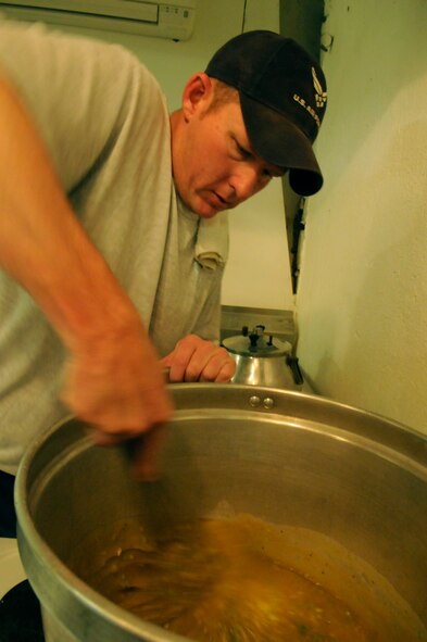 PANJSHIR PROVINCE, Afghanistan -- Tech. Sgt. Jeremy Louk, a native of Petal, Miss., deployed here from Barksdale Air Force Base, La., and Provincial Reconstruction Team Panjshir engineering superintendent of construction and development, prepares the base of the gumbo called roux, which Louk believes is the key to good gumbo. The roux consists of oil and flour and often takes 30 to 40 minutes to prepare. (U.S. Air Force photo by Tech. Sgt. Sean Mateo White)(released)  