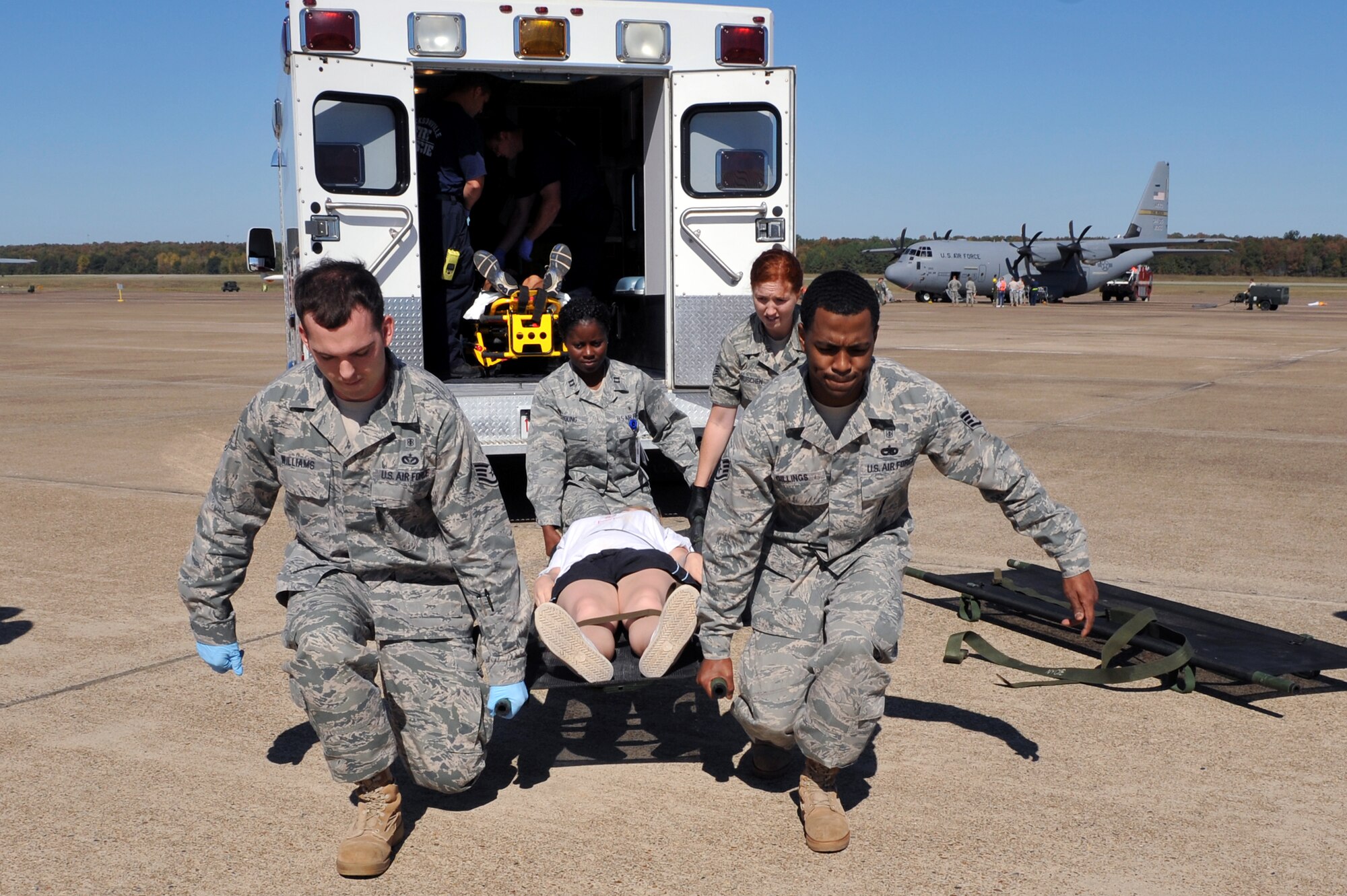 Members of the 19th Medical Group response team prepare to load an injured bystander during a Major Accident Response Exercise on the base flightline Oct. 1.   Little Rock Air Force Base Airmen responded to the simulated mass causality exercise in preparation for any emergency situation during the bases air show Oct. 9-10. (U.S. Air Force photo by Staff Sgt. Chris Willis)