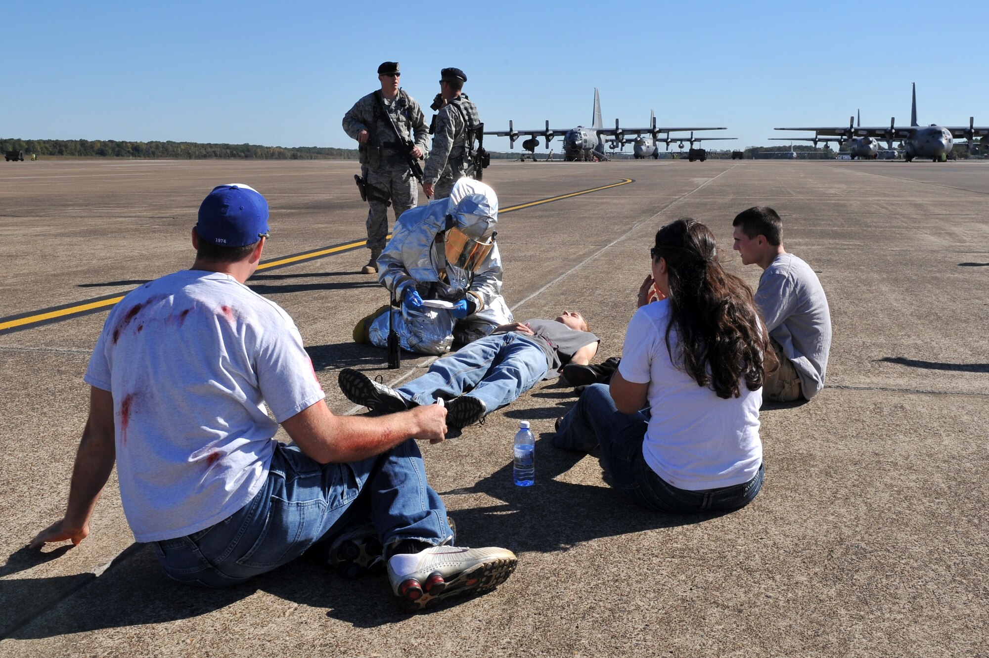Members of the 19th Civil Engineer Squadron fire department and 19th Security Forces Squadron respond to a Major Accident Response Exercise on the base flightline Oct. 1.  Little Rock Air Force Base Airmen conducted the mass causality exercise along with a simulated downed aircraft in preparation for the bases air show Oct. 9-10, which will be headlined by the Air Force Thunderbirds F-16 demonstration team.  (U.S. Air Force photo by Staff Sgt. Chris Willis)