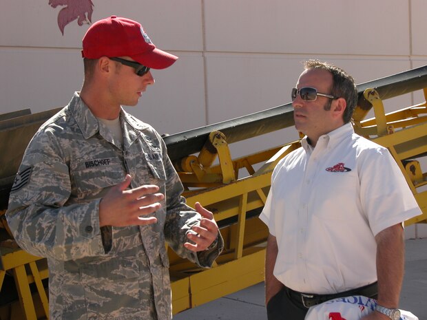 NELLIS AIR FORCE BASE, Nev.-- Tech. Sgt. Jason Bischoff (left), from the 820th RED HORSE Squadron, speaks with Kevin Ray, Red Horse Racing team manager, during a base visit here Sept. 24. The two "red horse" teams met for the first time after several years of anticipation. (U.S. Air Force photo / Tech. Sgt. Minette Mason)