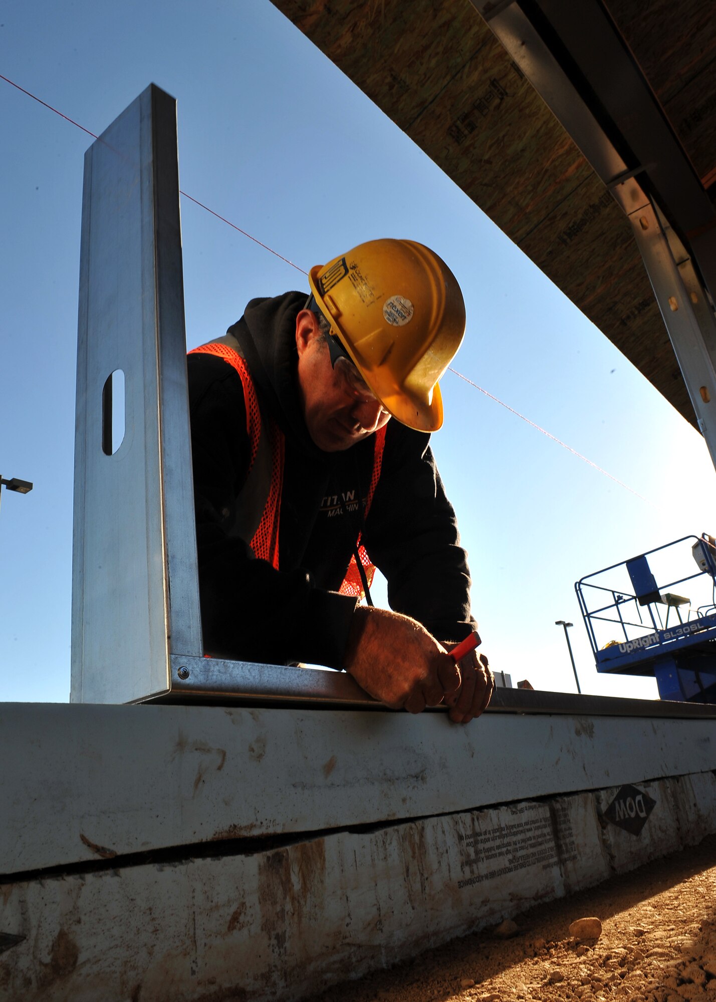 MINOT AIR FORCE BASE, N.D. -- David Siventson, a construction worker, marks the placement for support beams of the wall for the breezeway connecting the Base Exchange and Commissary here Oct. 1. The breezeway’s projected completion is slated for mid-December, providing a safe passageway between the two buildings for those harsh winter months. Construction projects like this are a continuing effort to improve living standards for Air Force Global Strike Command Airmen at Minot. (U.S. Air Force photo by Senior Airman Michael J. Veloz)