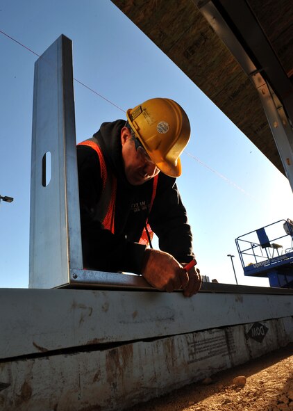 MINOT AIR FORCE BASE, N.D. -- David Siventson, a construction worker, marks the placement for support beams of the wall for the breezeway connecting the Base Exchange and Commissary here Oct. 1. The breezeway’s projected completion is slated for mid-December, providing a safe passageway between the two buildings for those harsh winter months. Construction projects like this are a continuing effort to improve living standards for Air Force Global Strike Command Airmen at Minot. (U.S. Air Force photo by Senior Airman Michael J. Veloz)