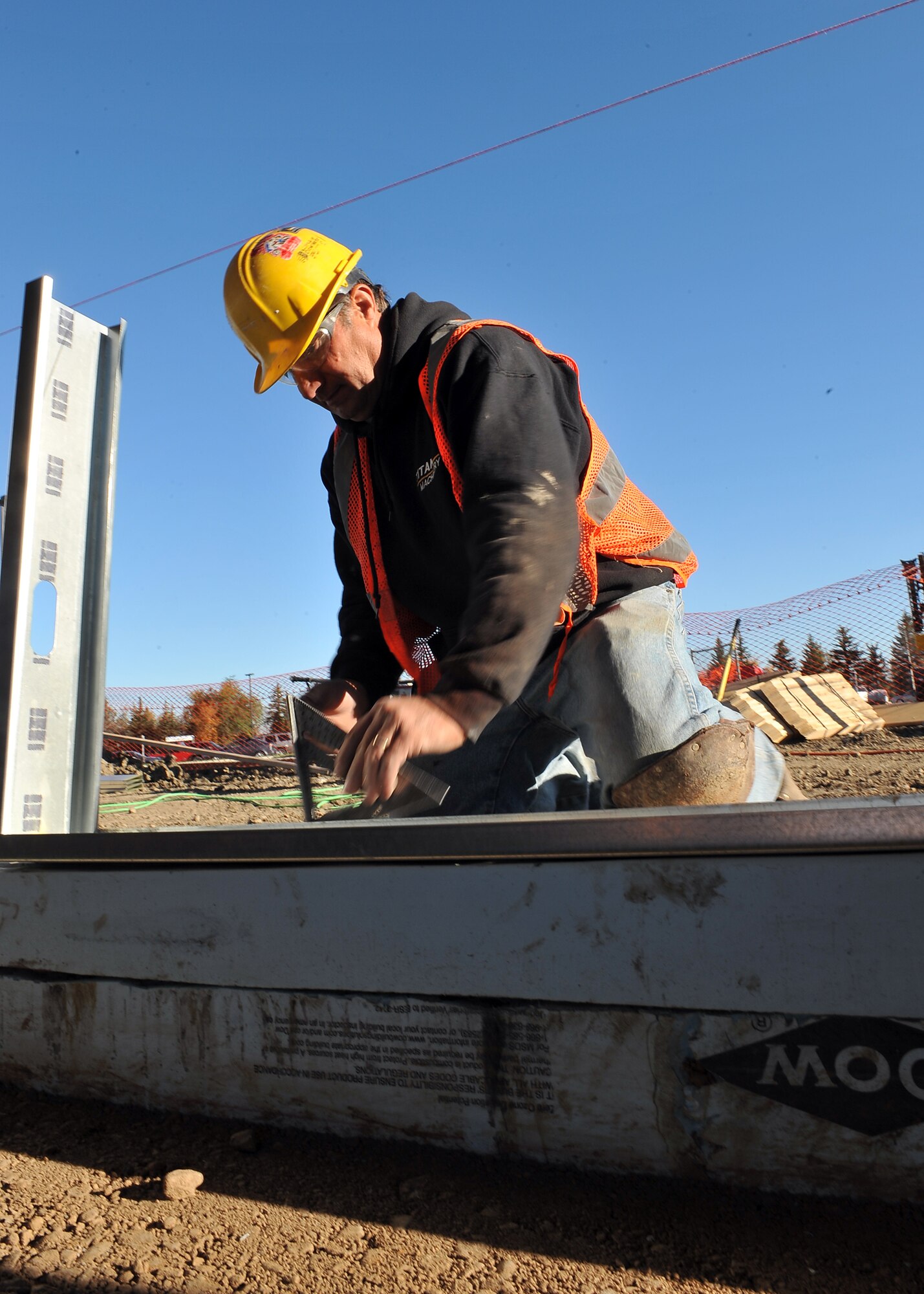 MINOT AIR FORCE BASE, N.D. -- David Siventson, a construction worker, marks the placement for support beams of the wall for the breezeway connecting the Base Exchange and Commissary here Oct. 1. The breezeway’s projected completion is slated for mid-December, providing a safe passageway between the two buildings for those harsh winter months. Construction projects like this are a continuing effort to improve living standards for Air Force Global Strike Command Airmen at Minot. (U.S. Air Force photo by Senior Airman Michael J. Veloz)