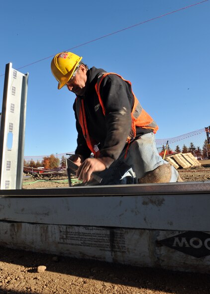 MINOT AIR FORCE BASE, N.D. -- David Siventson, a construction worker, marks the placement for support beams of the wall for the breezeway connecting the Base Exchange and Commissary here Oct. 1. The breezeway’s projected completion is slated for mid-December, providing a safe passageway between the two buildings for those harsh winter months. Construction projects like this are a continuing effort to improve living standards for Air Force Global Strike Command Airmen at Minot. (U.S. Air Force photo by Senior Airman Michael J. Veloz)