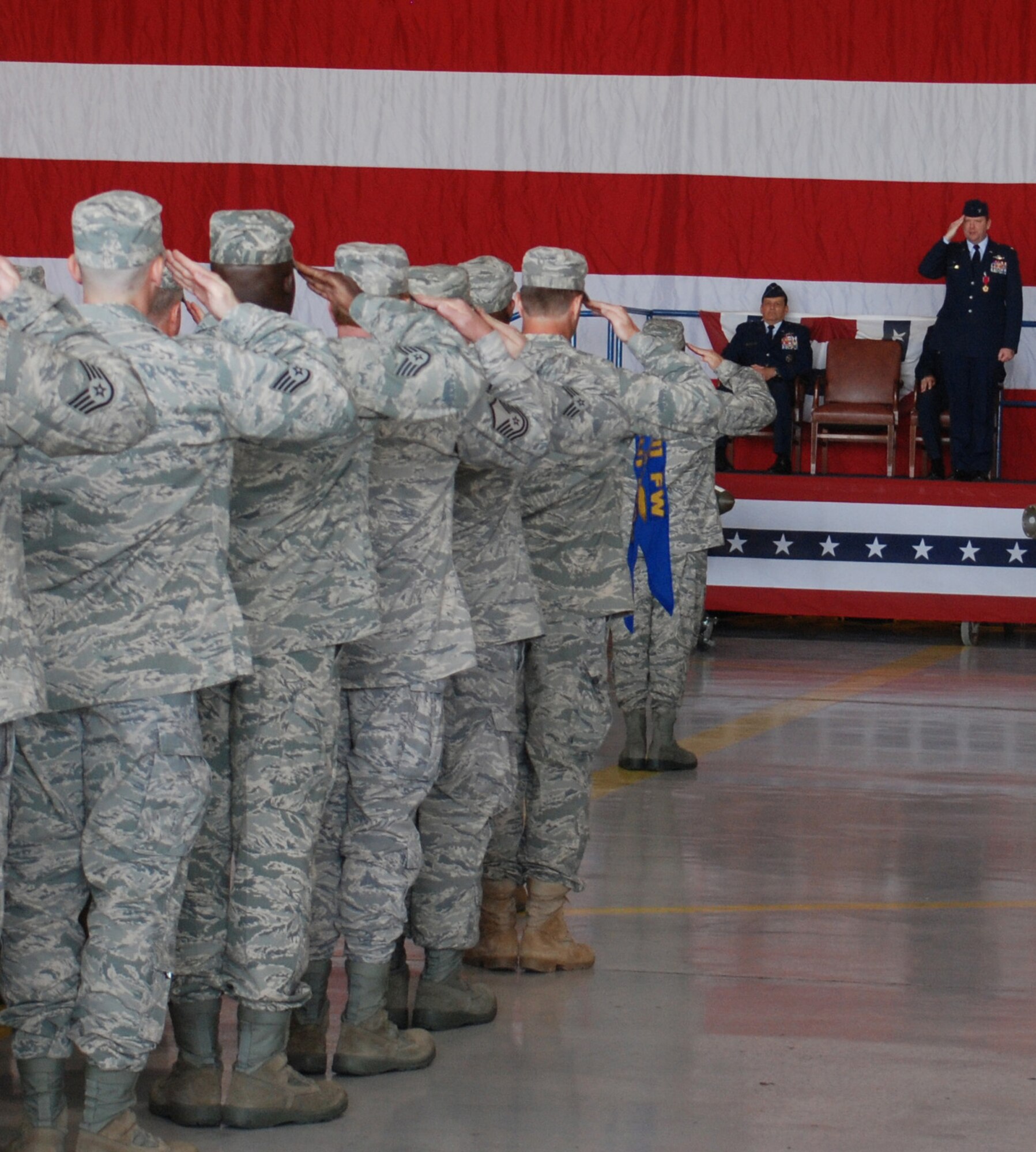 Colonel Richard Scobee (standing on stage) returns his final salute as 301st Fighter Wing commander. Shortly after, Colonel Ronald B. Miller became the new 301st Fighter Wing commander during a change of command ceremony Sunday, October 3. (U.S. Air Force Photo/A1C Melissa Harvey)